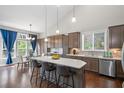 Well-appointed kitchen featuring a large island with seating, stainless steel appliances, and a view to the dining area at 139 Stargaze Rdg, Canton, GA 30114