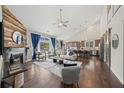 Open-concept living room boasts hardwood floors, vaulted ceiling, fireplace, and seamless flow to kitchen at 139 Stargaze Rdg, Canton, GA 30114