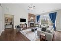 Comfortable living room with a fireplace and large windows offering scenic views of the surrounding landscape at 139 Stargaze Rdg, Canton, GA 30114