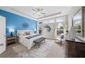 Spacious main bedroom featuring a tray ceiling, a blue accent wall, and large windows with natural light at 139 Stargaze Rdg, Canton, GA 30114