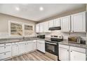 Well-lit kitchen featuring white cabinets, granite countertops, and stainless steel appliances at 165 Holly Nw Rd, Atlanta, GA 30314