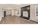 Inviting living room showcasing wood floors and a modern black brick fireplace at 165 Holly Nw Rd, Atlanta, GA 30314