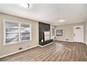 Bright living room featuring wood floors, a black brick fireplace, and natural light at 165 Holly Nw Rd, Atlanta, GA 30314