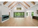 Open-concept living room with fireplace, hardwood floors, and access to the outdoor patio at 402 Chattahoochee St, Roswell, GA 30075