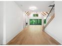 Spacious living room with hardwood floors, fireplace, and vaulted ceilings with exposed beams at 402 Chattahoochee St, Roswell, GA 30075