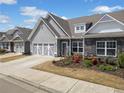 View of the charming home exterior with garage, stone accents, and sidewalk appeal at 510 Riverview Ln, Canton, GA 30114
