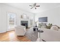 Sun-filled living room features a decorative fireplace, hardwood floors, and a comfortable seating arrangement at 218 Ridley Ln, Decatur, GA 30030