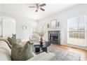 Bright living room with fireplace, hardwood floors, neutral furniture, and large windows, creating a cozy and inviting atmosphere at 218 Ridley Ln, Decatur, GA 30030