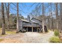 Rear exterior view with a large deck and a covered patio area at 3341 Camelot Way, Loganville, GA 30052