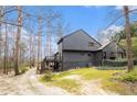 Exterior view showcasing the rear of a well-maintained home with lush greenery at 3341 Camelot Way, Loganville, GA 30052
