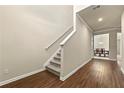 A home entryway with a staircase, hardwood floors, and neutral wall colors at 11973 Lovejoy Crossing Way, Hampton, GA 30228