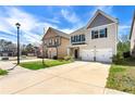 Suburban home exterior with a two-car garage, driveway, and neat front lawn at 11973 Lovejoy Crossing Way, Hampton, GA 30228