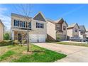 A two-story home with a two-car garage, green lawn, and sunny skies at 11973 Lovejoy Crossing Way, Hampton, GA 30228