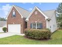 Charming brick home with attached garage and lush landscaping at 3804 Hawk Tail Dr, Loganville, GA 30052