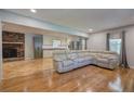 Open concept living space with hardwood floors, brick fireplace, and view into the updated kitchen at 4361 Stanley Dr, Powder Springs, GA 30127