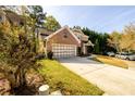 A two-story home with a brick facade, a two-car garage, and a long driveway are all visible at 742 Hope Hollow Ln, Loganville, GA 30052