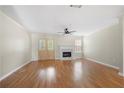 Bright living room boasts hardwood floors, a marble fireplace, ceiling fan and double french doors at 5908 Trent Walk Dr, Lithonia, GA 30038