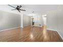 Open-concept living room featuring hardwood floors, a ceiling fan, and easy access to the kitchen at 5908 Trent Walk Dr, Lithonia, GA 30038