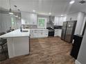 Bright kitchen featuring stainless steel appliances, white cabinets, and a large island with seating at 1155 Christian Se Cir, Conyers, GA 30013