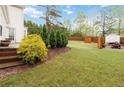 Spacious backyard with lush lawn, mature trees, wooden fence and storage shed at 4264 Parks Ridge Dr, Snellville, GA 30039