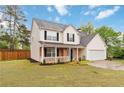 Traditional home with a two-car garage, porch, and well-maintained lawn at 4264 Parks Ridge Dr, Snellville, GA 30039