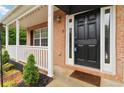 Close-up of the front door and porch, with brick accents and fresh landscaping at 4264 Parks Ridge Dr, Snellville, GA 30039