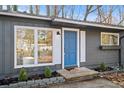 Close-up of the front door with sidelights and a flower box under the window at 799 Kennesaw Dr, Forest Park, GA 30297