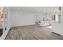 Bright and airy living room featuring wood floors and a modern kitchen island at 799 Kennesaw Dr, Forest Park, GA 30297
