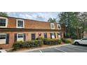 Brick townhouse displaying unique dormer windows, black shutters, and attractive front landscaping at 1261 Lavista Ne Rd # A-3, Atlanta, GA 30324