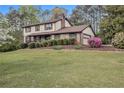 Traditional two-story home with an attached garage and a lush green lawn at 1757 Colonial South Sw Dr, Conyers, GA 30094