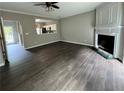 Open living room with hardwood floors, fireplace, and a view into the kitchen at 4645 Valais Ct # 121, Alpharetta, GA 30022