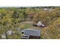 An aerial view highlights the property's spacious backyard and mature trees at 6957 Mason Creek Rd, Douglasville, GA 30135
