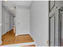 Bright entryway with hardwood floors, white trim, gray walls, and a coat closet at 1735 Peachtree Ne St # 624, Atlanta, GA 30309