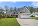 Charming two-story home with stone accents, a well-manicured lawn, and an attached two-car garage at 2232 Ann Ln, Lithia Springs, GA 30122