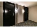 Hallway with textured gray carpet and 2 black doors at 2626 Peachtree Nw Rd # 412, Atlanta, GA 30305