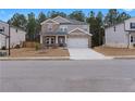 Attractive two-story home with a stone and siding exterior, a two-car garage, and a welcoming front porch at 4171 Dean Grove Way, Loganville, GA 30052