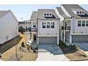Charming two-story townhome with a gray garage door, balcony, and landscaped front yard at 1433 Halpern Ln, Kennesaw, GA 30144