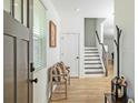 Inviting foyer with hardwood floors, bench seating, and stairs leading to the upper level at 1433 Halpern Ln, Kennesaw, GA 30144