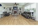 Bright living room with fireplace, hardwood floors, modern furniture, and ample natural light at 1433 Halpern Ln, Kennesaw, GA 30144