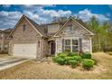 Charming single-Gathering home with a combination of brick and stone facade, and manicured front yard landscaping at 164 Madison Grace Ave, Mcdonough, GA 30252