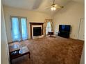 Spacious living room with fireplace, ceiling fan and natural light at 204 Appalachee Church Rd, Auburn, GA 30011