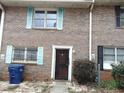 Brick townhouse with colorful shutters and well-maintained landscaping at 3695 Church St, Clarkston, GA 30021