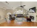 Bright living room with vaulted ceilings, fireplace, chandelier, and hardwood floors at 5960 Sarah Orr Ln, Cumming, GA 30040