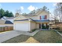 Charming two-story home with a two-car garage and well-maintained landscaping at 792 Russell Dr, Riverdale, GA 30296