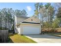 Charming two-story home with a two-car garage and well-maintained landscaping at 792 Russell Dr, Riverdale, GA 30296