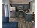 Updated kitchen featuring stainless steel appliances, modern cabinets, stylish countertops, and open layout perfect for entertaining at 1503 Korona Ct, Woodstock, GA 30188