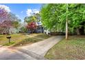 Charming home with a covered porch, long driveway, mature trees, and landscaping at 2425 Shiloh Sw Dr, Marietta, GA 30064