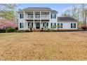 Charming two-story home with a covered porch, balcony, and a spacious front yard at 3642 Falls Trl, Winston, GA 30187