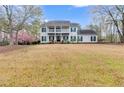 Charming two-story home with a covered porch, balcony, and a spacious front yard at 3642 Falls Trl, Winston, GA 30187