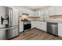 Modern kitchen featuring stainless steel appliances, white cabinets, and beautiful countertops for culinary enthusiasts at 1248 Falling Water Se Dr, Smyrna, GA 30080